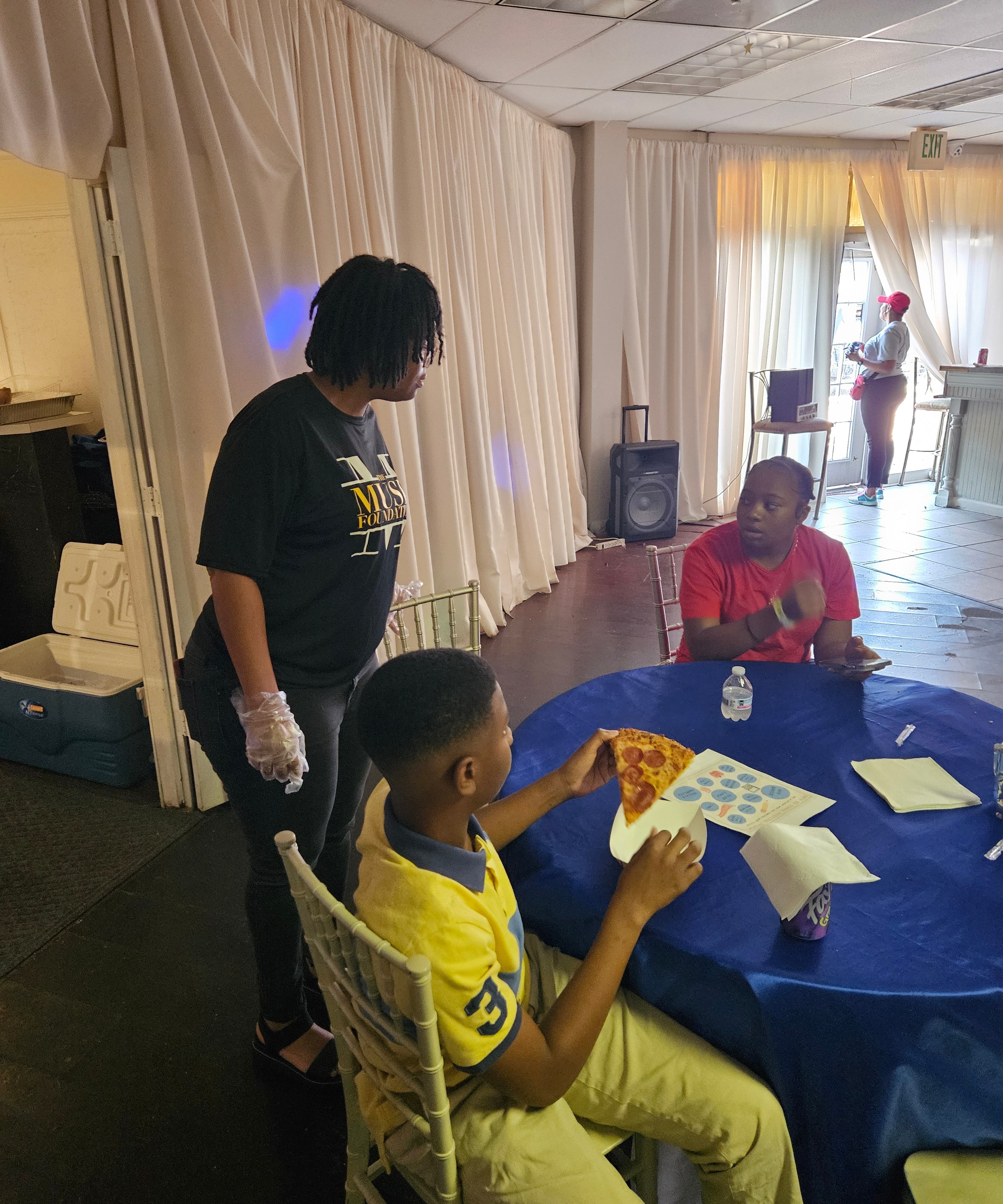 Volunteer and community member signing in at the registration table