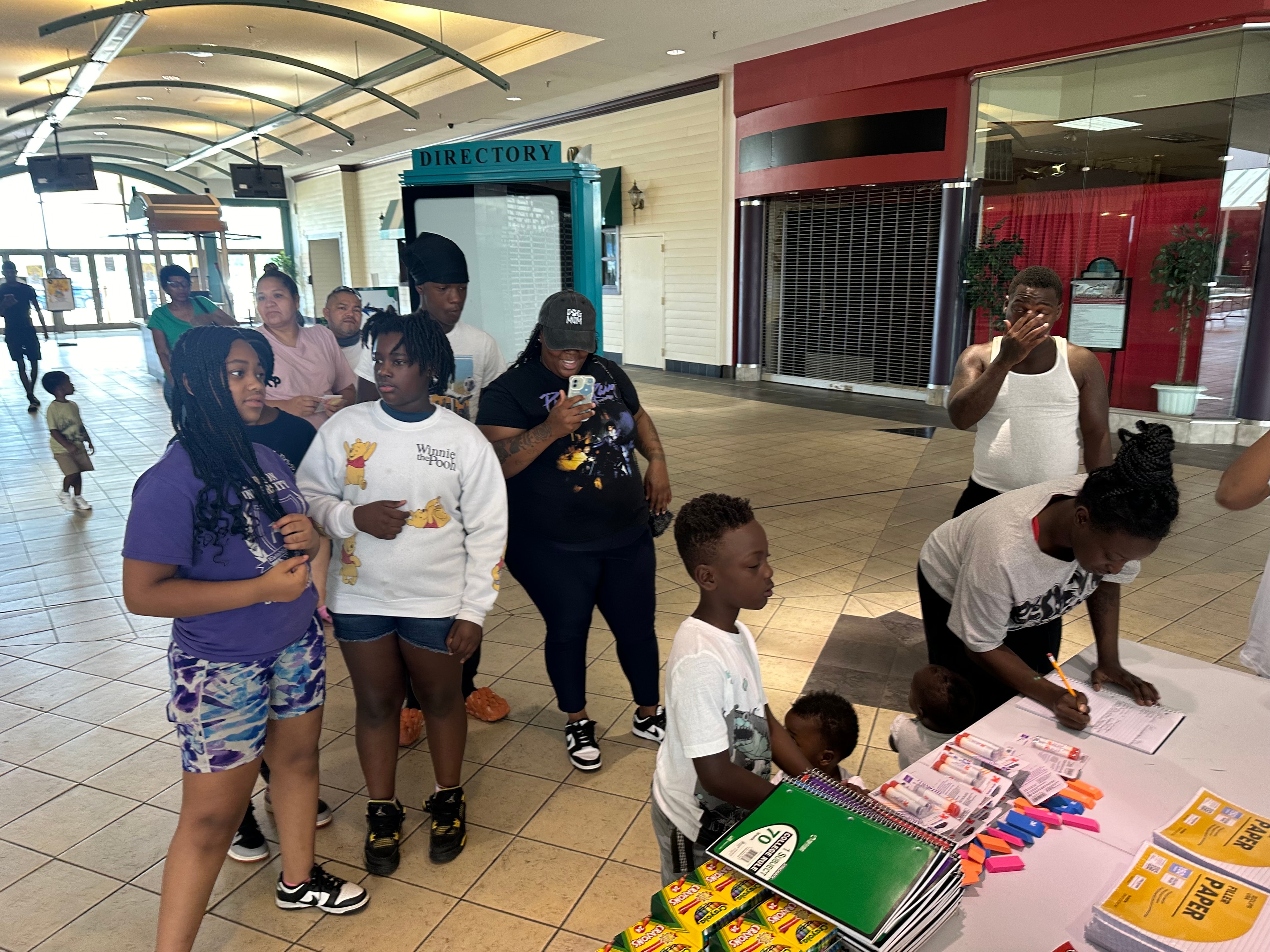 Community members checking in at the Muse Foundation event table